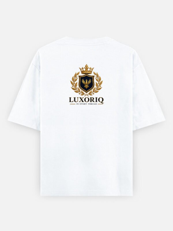 THE CREST TEE — LUXORIQ PHOENIX in white, back view with the LUXORIQ crest, wordmark and IN EVERY THREAD