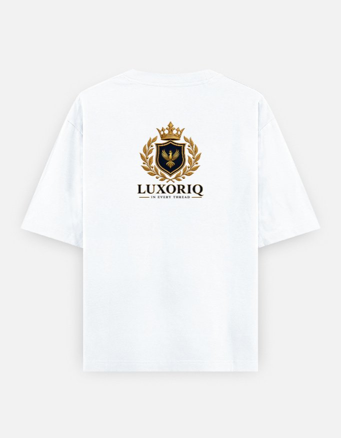 THE CREST TEE — LUXORIQ PHOENIX in white, back view with the LUXORIQ crest, wordmark and IN EVERY THREAD
