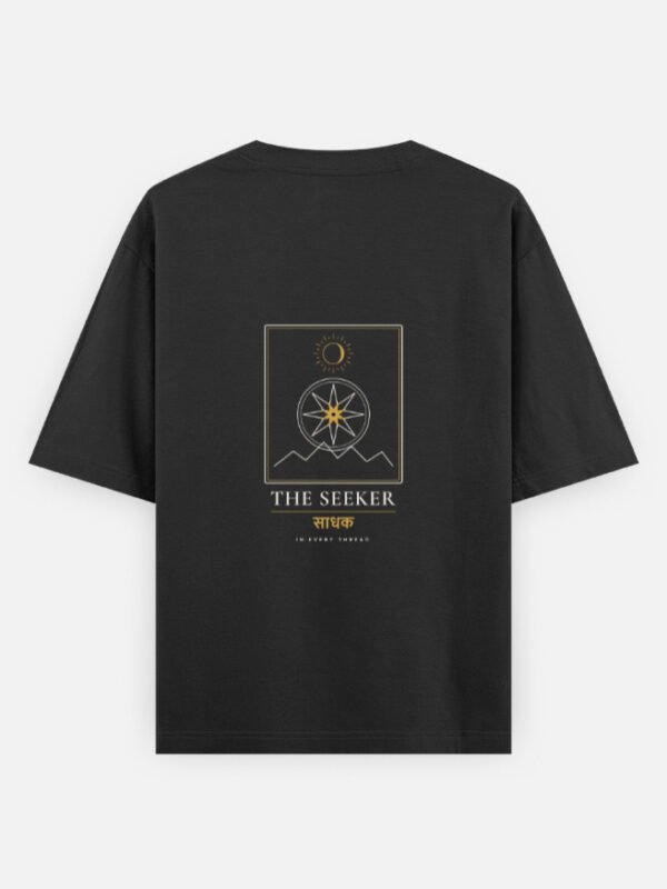 the-seeker-oversized-tee-black-back THE SEEKER — Oversized Tee in black, back view with the compass-star archetype card on the back
