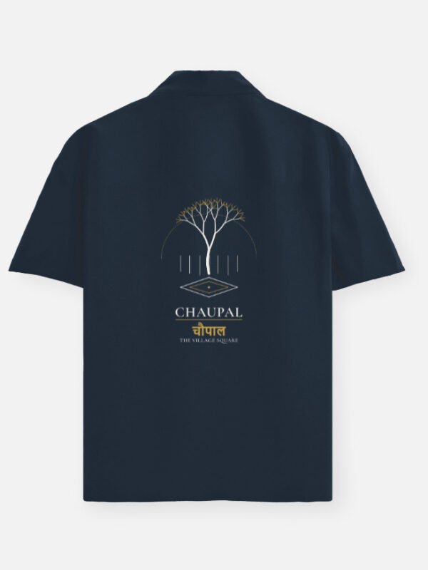 chaupal-oversized-shirt-navy-blue CHAUPAL — Oversized Shirt in navy blue, back view with a banyan canopy over a village square