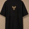 THE HOUSE TEE — INK — editorial back (flat) Editorial lookbook mockup: black THE HOUSE TEE — INK laid flat, back view with the small gold-coloured Luxoriq phoenix crest